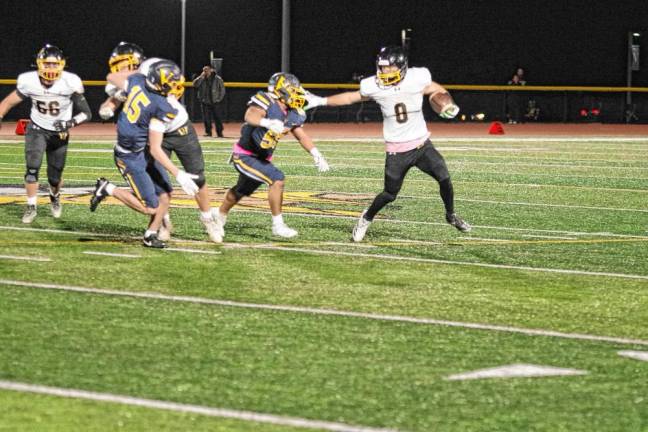 <b>West Milford ball carrier Chase Tyburczy attempts to evade Vernon defenders.</b>