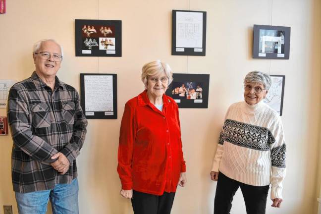 EX1 From left, Bill Madden, Carol Heinz and Marge Dooley with artwork in the Friends of West Milford Township Library exhibit. (Photos by Rich Adamonis)