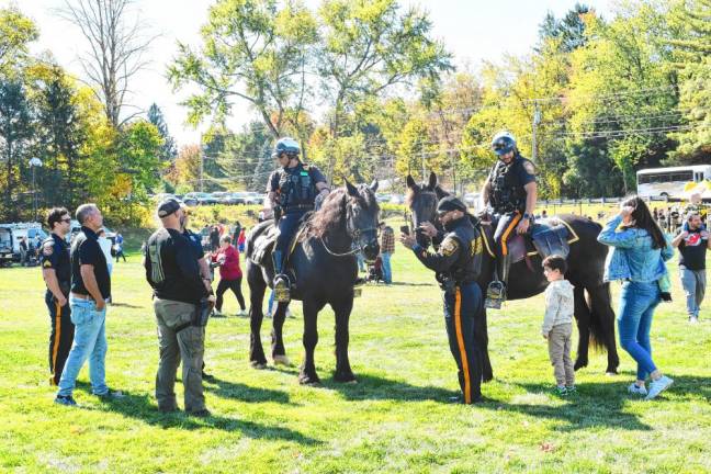 Mounted sheriff’s officers talk to residents at the annual event.