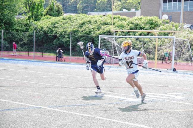 BL1 Jefferson's Alex Johns carries the ball with his crosse while being shadowed by Ramsey's Owen Crowley in the quarterfinal round of the NJSIAA North Jersey, Group 1 tournament May 30. Ramsey won, 13-11. (Photos by George Leroy Hunter)