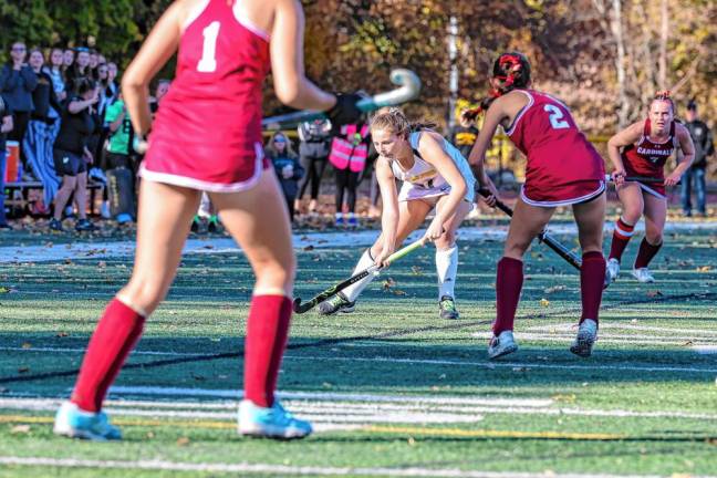 Addy Seidner of West Milford controls the ball at midfield while surrounded by Pompton Lakes defenders.