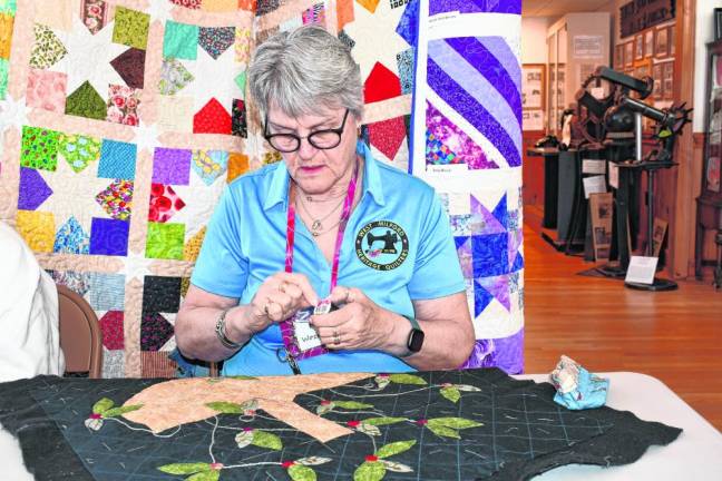 Meg Woznicki of Oak Ridge demonstrates hand quilting.