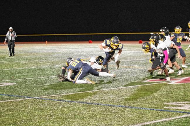 <b>Vernon wideout Gavin Bruno (22) is grabbed by a West Milford defender.</b>