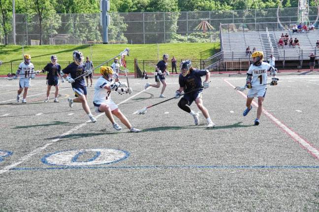 Ramsey's Dan Capuano (5) scoops up a ground ball with his crosse.