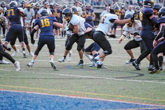 <b>WJ4 A West Milford ball carrier is grabbed while trying to break through the Jefferson defense.</b>