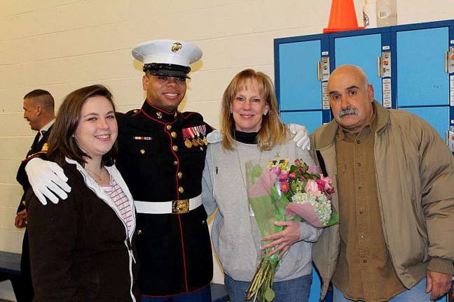 Honoring Brian, from left, are his cousin Kaitlin Reich, his Marine recruiter Sergeant Sangster and his parents, Shirley and Nino.