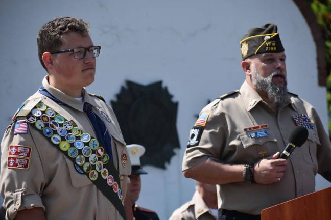 WMP2 Rudy Hass, senior vice commander of Veterans of Foreign Wars Post 7198 in West Milford, thanks Eagle Scout Edward Satkowski, left, for raising flagpoles for each of the U.S. military service branches at Veterans Park.