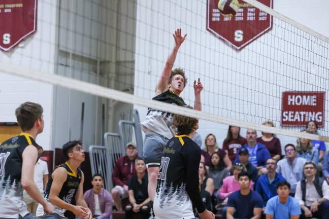 Sean McNally of West Milford hits a free ball back over the net in the first game against Summit.