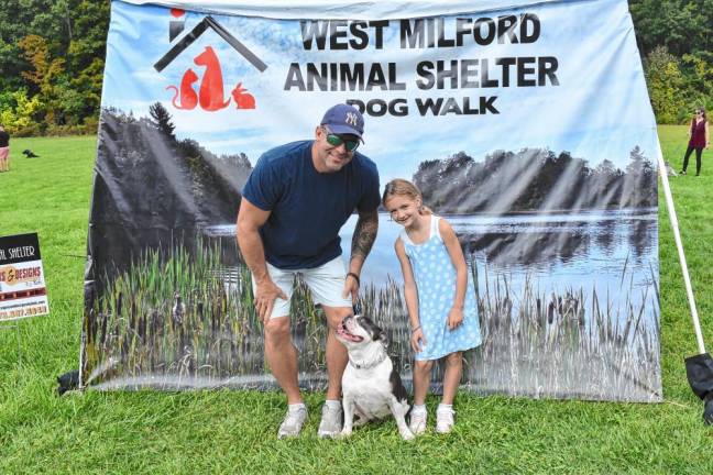 Police Chief Shannon Sommerville and his daughter pose with their dog at the event.