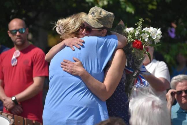 WMP7 Tonya Butkus, right, and Shirley Parrello embrace at the ceremony. Butkus’s brother Jason and the Parrellos’ son Brian were killed in Operation Iraqi Freedom.