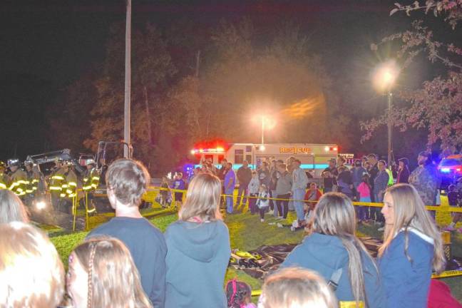 Residents watch a demonstration of what firefighters would do if a tree fell on a vehicle. (Photos by Fred Ashplant)