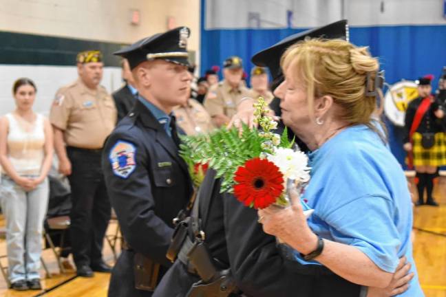 Gold Star Mother Shirley Parrello accepts a flower bouquet in honor of her son Brian, who was killed in Operation Iraqi Freedom in 2005 at age 19.