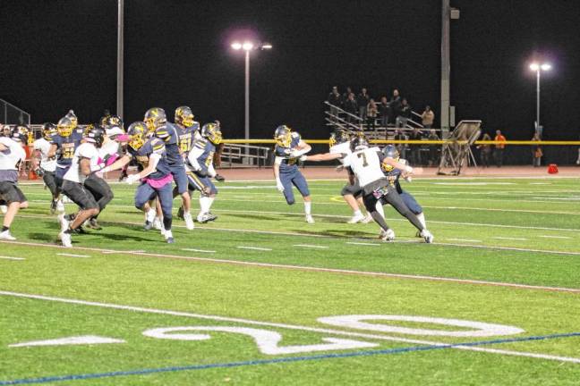 <b>Vernon wideout Gavin Bruno (22) is grabbed by a West Milford defender.</b>