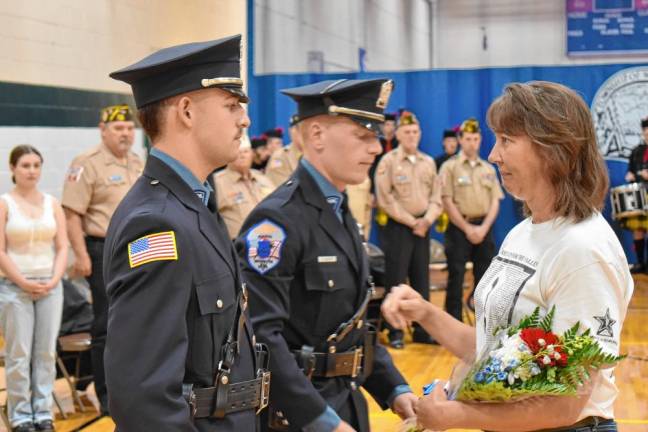 Flowers are presented to Gold Star family member Tonya Butkus, whose brother, Jason, was killed in Operation Iraqi Freedom in 2007. The Army staff sergeant’s Humvee was hit by a rocket-propelled grenade in Baghdad. He was 34.