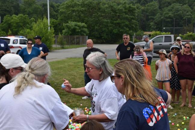 Village trustee Nancy Clifford holds one of the numbered balls.