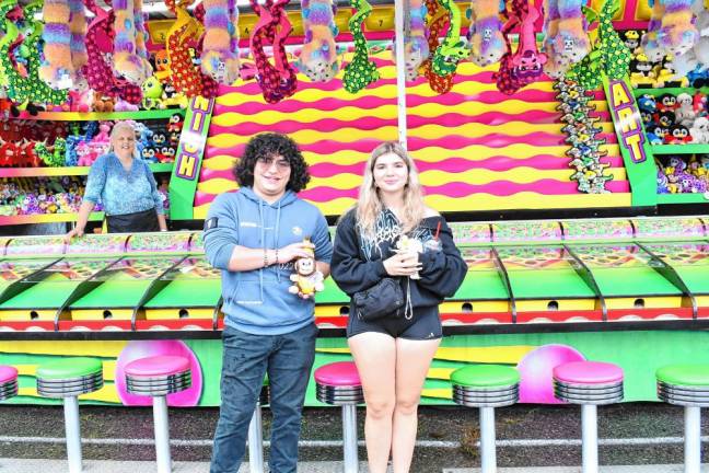 Michael Schiaratura of Bogota and Mia Harrison of West Milford with plush toys they won at a carnival game. (Photo by Maria Kovic)