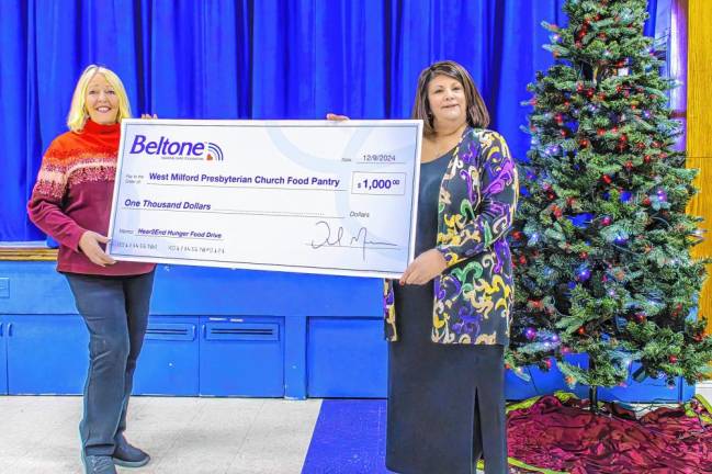 Judy Kenney, right, owner and outreach manager of Beltone Hearing Aid Center of West Milford, presents a check for $1,000 to Patricia Wright for the West Milford Presbyterian Church Food Pantry. (Photo by Don Wright)