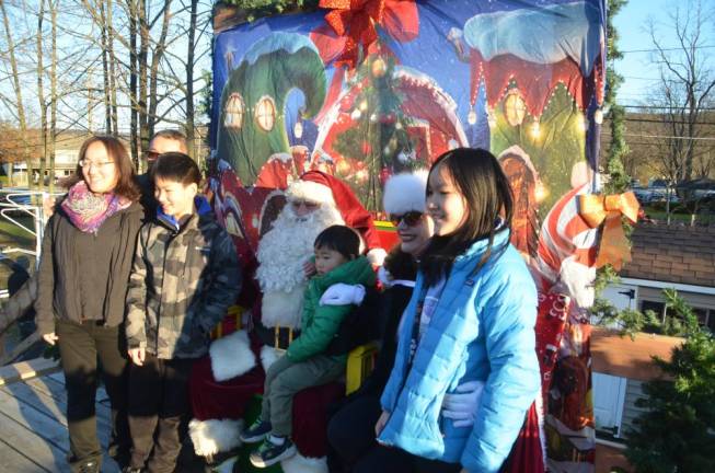 Santa and Mrs. Claus take pictures with a family..