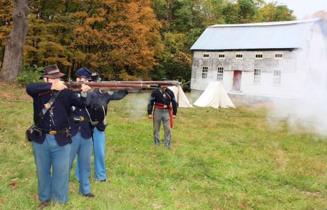 Ready, aim, fire. Civil War reenactors brought history to life at the Long Pond Ironworks last Saturday. Representing the 6th New Hampshire Volunteers, the camp site is authentic. Photos by Ginny Raue