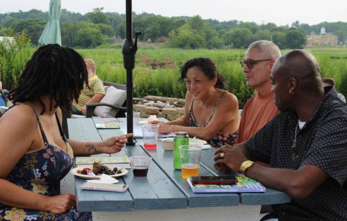 Tour-goers share garden tips and compare notes from the day at the after party in Chester, NY, overlooking the black dirt.