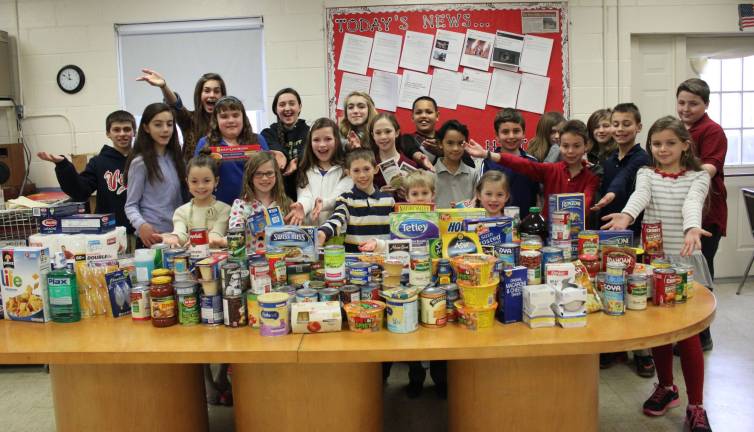 Students at Ringwood Christian School show the food they collected for the Ringwood Food Bank.