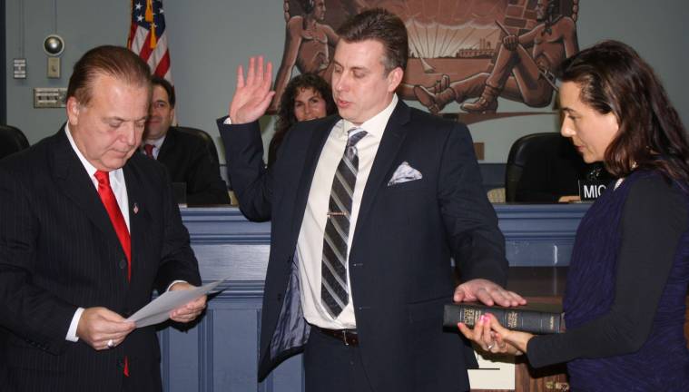 Newly minted Councilman Tim Wagner, center, is joined by his wife, Daina, as state Senator Joseph Pennacchio gives the oath of office to him. Wagner is new to the township council.