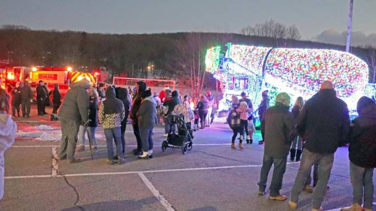 Residents gather near the decorated Salomone Bros. cement mixer.