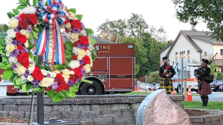 Joseph Smolinski and Jess Pritchett play bagpipes during the ceremony.