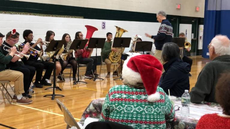 HP1 Brian McLaughlin directs the West Milford High School Wind Ensemble Brass at a holiday party for senior citizens Thursday, Dec. 21.