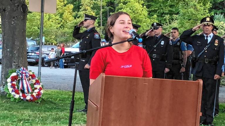 Gillian Rasp sings the National Anthem during the ceremony.