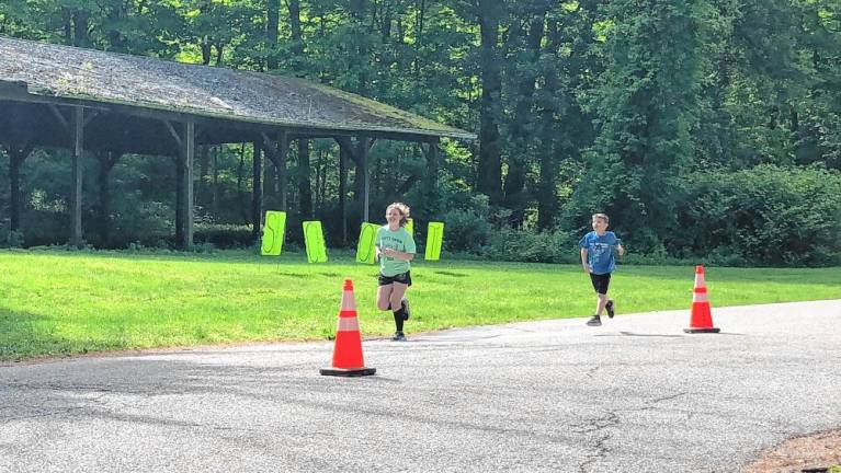 Two runners lead participants in the event Sunday, May 19 at the West Milford Recreation Center.