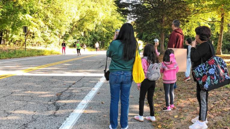 Spectators cheer on the runners.