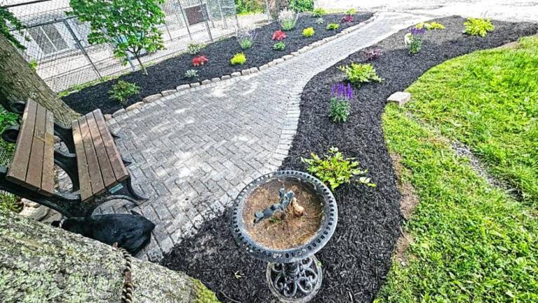 The new garden incorporates a park bench with plaque for Sharon Coney.