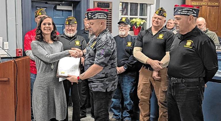 West Milford VFW Post 7198 Commander Rudy Hass presents a plaque to Nicole Petrosillo at a recent Township Council meeting.