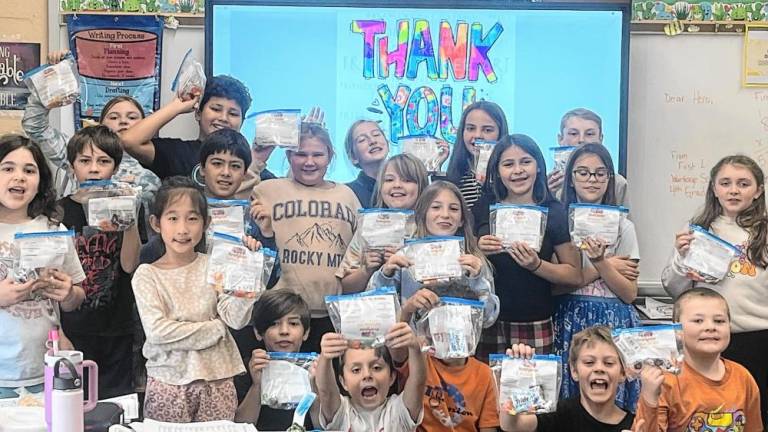 Wantage School students hold letters that they sent to Fire Company 4 in West Milford. (Photo provided)