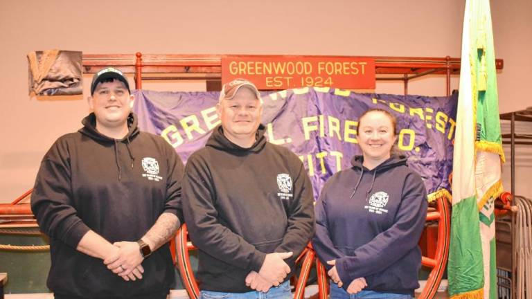 From left, Chief Keith Weber, current president and former chief Mike Spoelstra, and Lt. Kathryn ‘Kat’ Weber of the Greenwood Forest Fire Company #3, which is 100 years old. (Photo by Rich Adamonis)