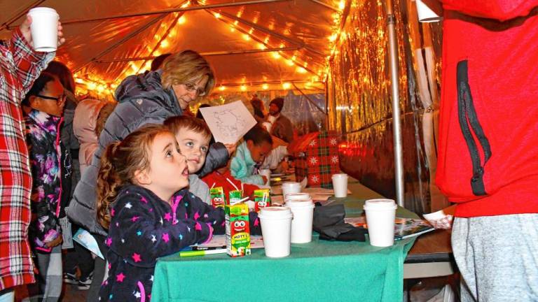 <b>Residents get drinks during the Festival of Lights celebration Saturday, Nov. 16 at the Newton Medical Center. (Photo by Maria Kovic)</b>