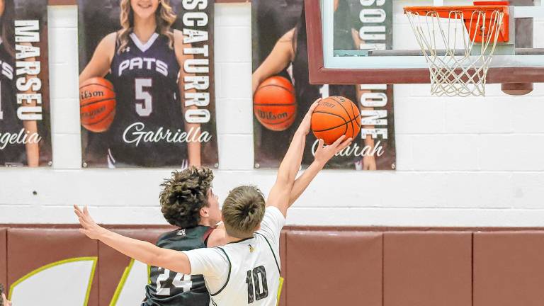 Early in the second half of the Passaic County Tournament quarterfinal game Saturday, Feb. 15, West Milford’s Ognjen Ljusic blocks the shot of Brooklyn Jelinsky. Wayne Hills won, 63-39. The girls team also lost in the PCT quarterfinal round to Passaic Tech, 56-48. (Photo by Glenn Clark)