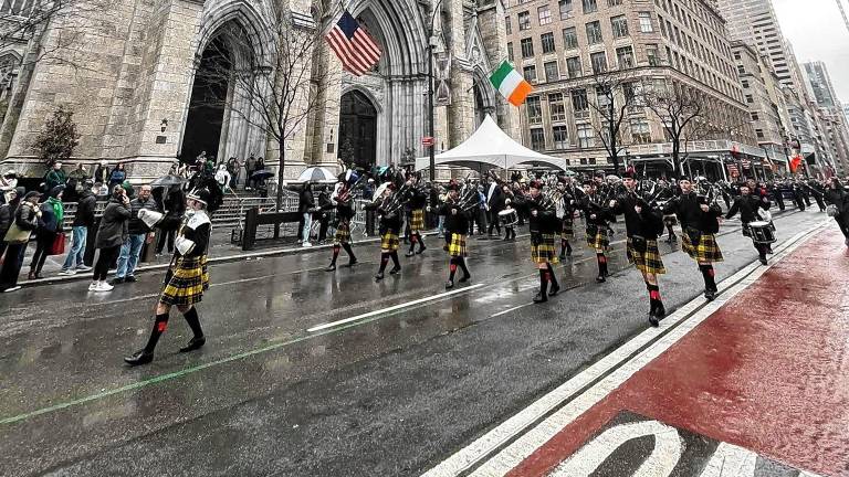 The Pipes &amp; Drums of the West Milford Highlander Band march past St. Patrick’s Cathedral on Monday, March 17 in New York City. (Photos provided)