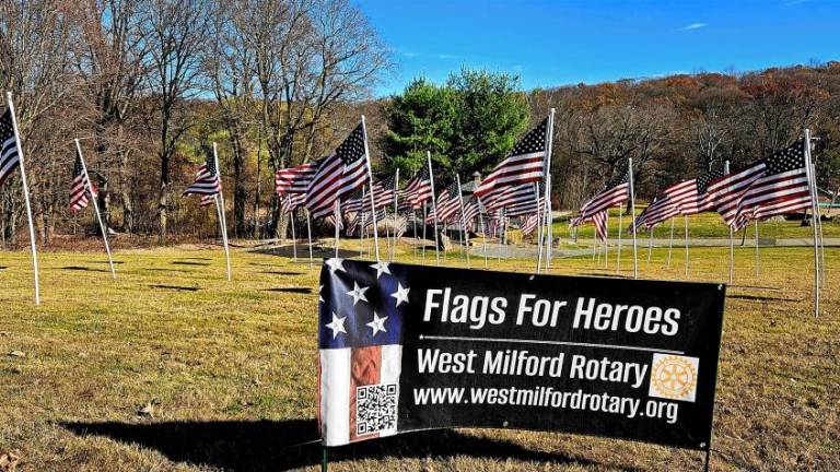 FL1 The West Milford PBA Local 162 honors township residents killed in action by participating in the West Milford Rotary Club’s Flags for Heroes project. (Photo by Rich Adamonis)